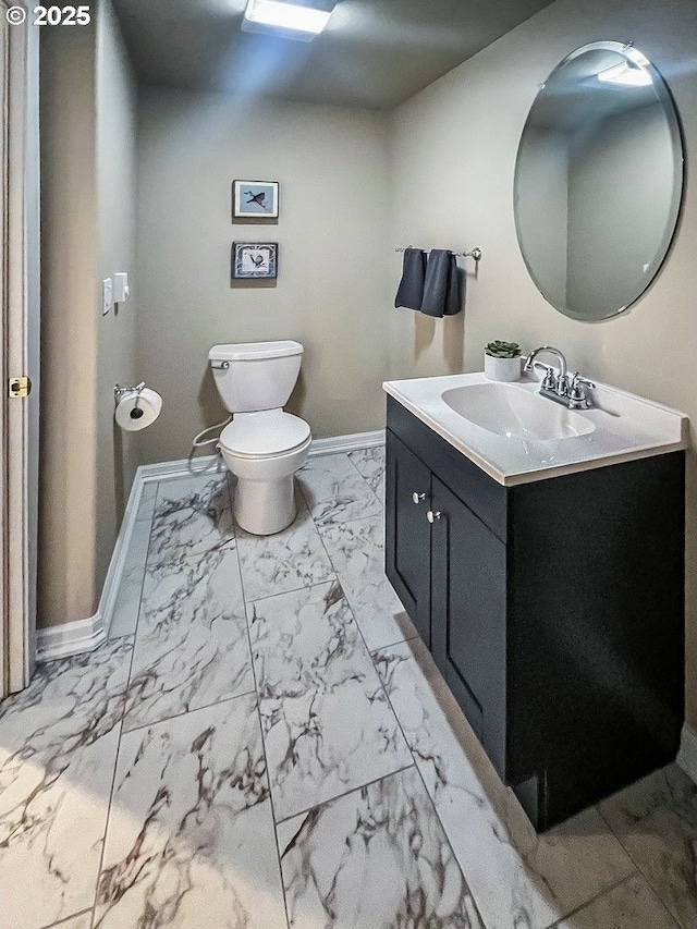 1500 SW Miller Ct, Gresham, OR 97080 - bathroom with marble look tiles, vanity, toilet, and baseboards