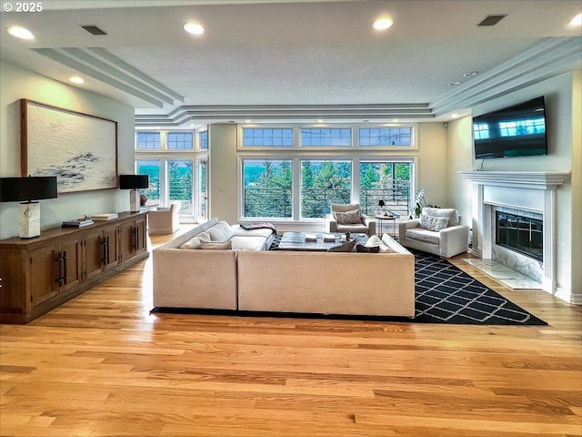 1500 SW Miller Ct, Gresham, OR 97080 - living area featuring a fireplace with flush hearth, light wood finished floors, plenty of natural light, recessed lighting, and ornamental molding