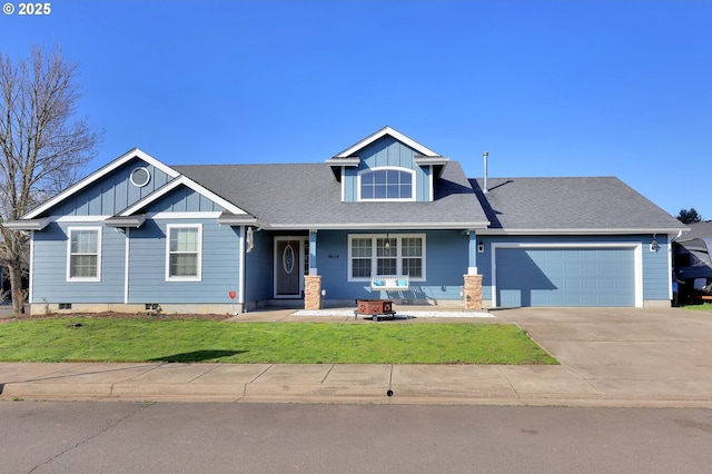 craftsman-style house featuring a shingled roof, concrete driveway, an attached garage, board and batten siding, and a front lawn