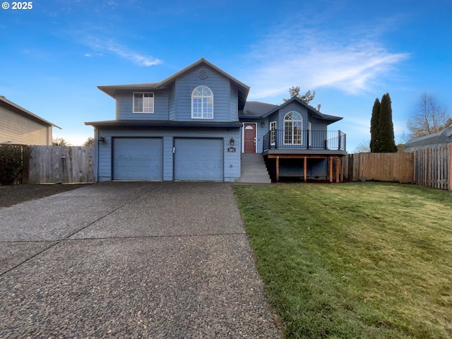 view of front of property featuring a garage, fence, concrete driveway, and a front yard