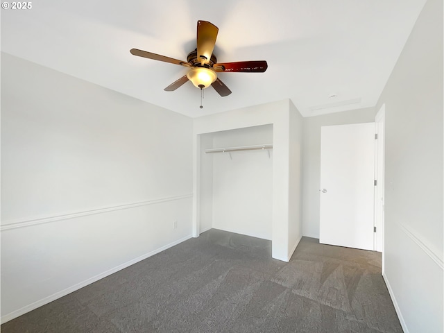 unfurnished bedroom with a ceiling fan, dark colored carpet, a closet, and baseboards