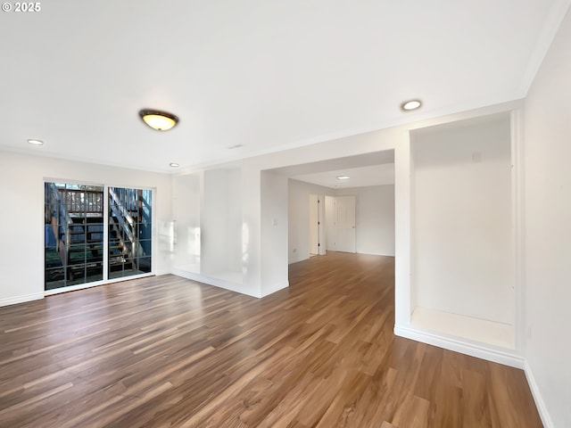 empty room featuring wood finished floors and baseboards