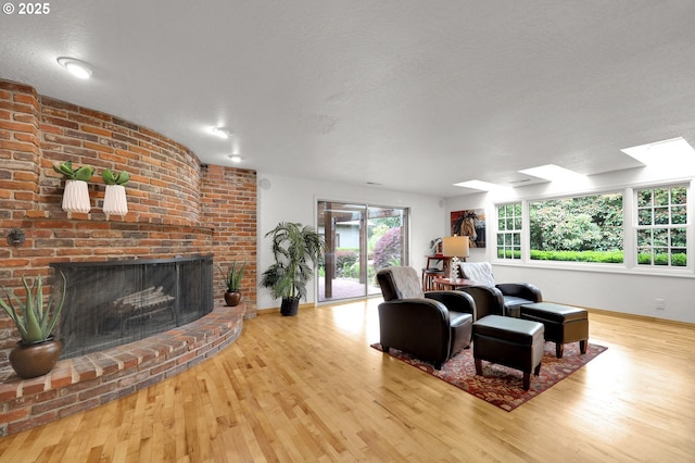 996 Lariat Dr, Eugene, OR 97401 - living room featuring a skylight, wood finished floors, a fireplace, and baseboards