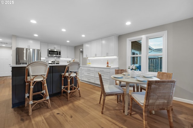 dining area with light hardwood / wood-style flooring