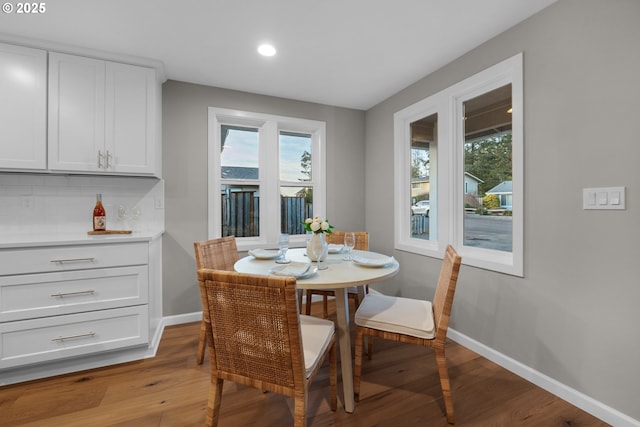 dining space with wood-type flooring