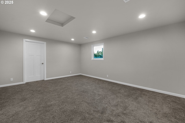 spare room featuring dark colored carpet