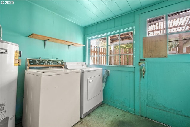 laundry area featuring water heater, separate washer and dryer, and laundry area