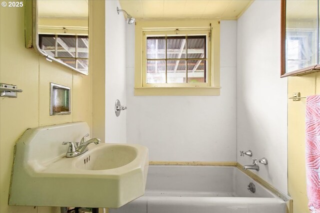 bathroom featuring a bathing tub and a sink