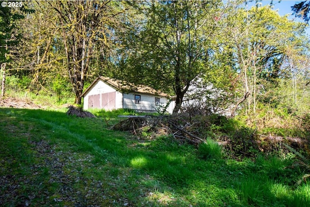 view of yard featuring a storage shed and an outbuilding