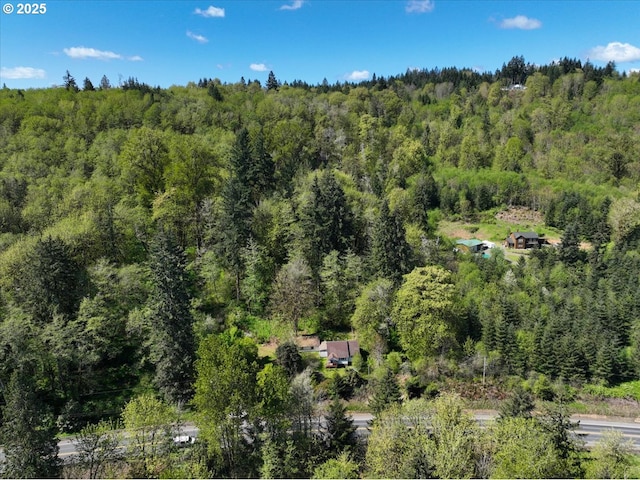 drone / aerial view with a wooded view