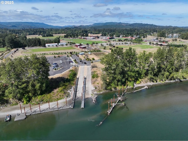 drone / aerial view featuring a water and mountain view