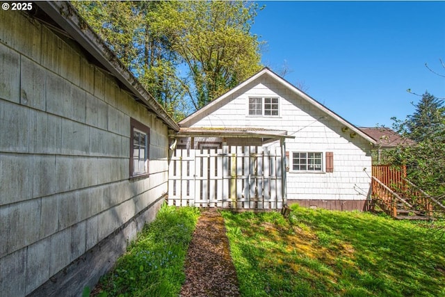 view of side of property featuring fence