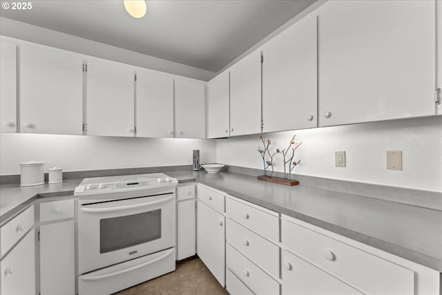 5858 S Riveridge Ln Unit 24, Portland, OR 97239 - kitchen featuring electric range, white cabinets, and tile patterned floors