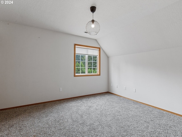 14300 NE Axford Rd, Battle Ground, WA 98604 - bonus room featuring carpet flooring, vaulted ceiling, baseboards, and a textured ceiling