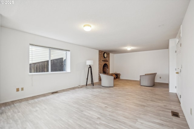213 Hidalgo St, Lake Oswego, OR 97035 - below grade area with light wood-type flooring and a fireplace