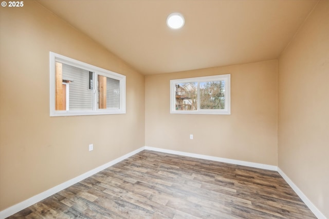 213 Hidalgo St, Lake Oswego, OR 97035 - empty room with wood finished floors, vaulted ceiling, and baseboards