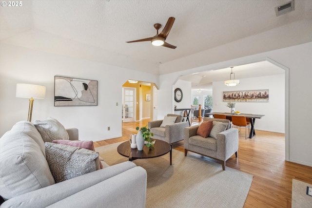 213 Hidalgo St, Lake Oswego, OR 97035 - living room featuring arched walkways, ceiling fan, light wood finished floors, and baseboards