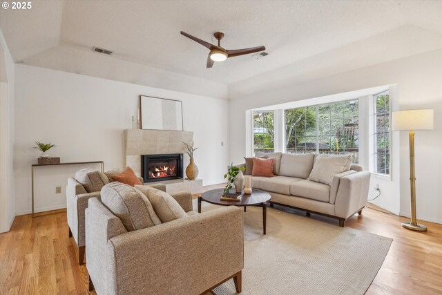 213 Hidalgo St, Lake Oswego, OR 97035 - living room featuring a ceiling fan, light wood-style floors, a fireplace, and baseboards