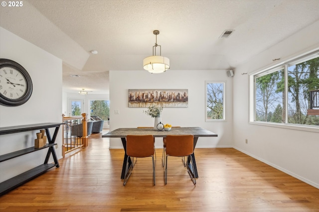213 Hidalgo St, Lake Oswego, OR 97035 - dining room with light wood-type flooring, a textured ceiling, and baseboards