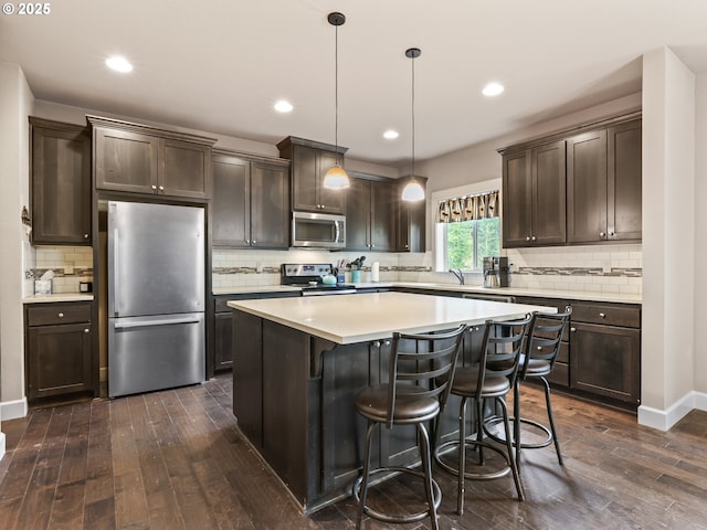 1725 NE Currin Creek Dr, Estacada, OR 97023 - kitchen featuring stainless steel appliances, dark brown cabinets, dark wood finished floors, and backsplash