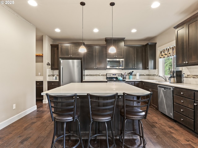 1725 NE Currin Creek Dr, Estacada, OR 97023 - kitchen with appliances with stainless steel finishes, dark brown cabinets, and a kitchen island