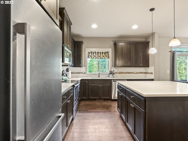 1725 NE Currin Creek Dr, Estacada, OR 97023 - kitchen with backsplash, dark wood-style flooring, dark brown cabinets, and stainless steel appliances