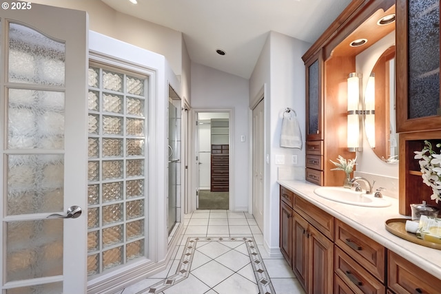 bathroom featuring french doors, an enclosed shower, vaulted ceiling, vanity, and tile patterned flooring