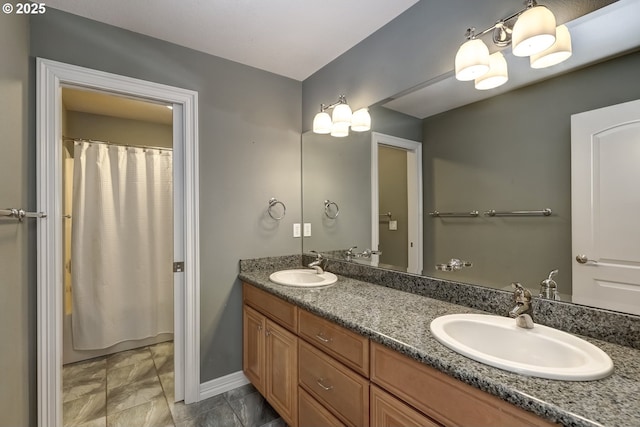 bathroom featuring vanity and curtained shower