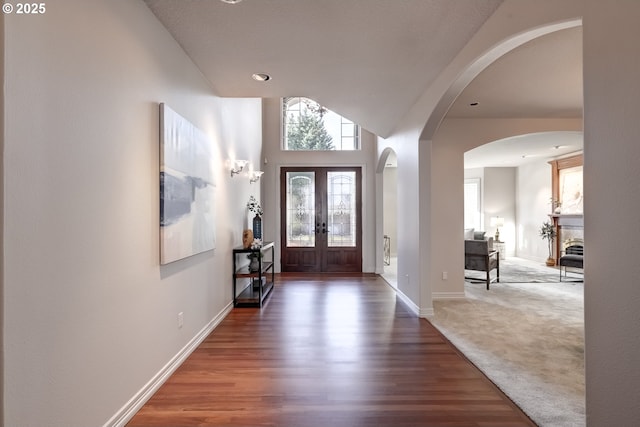 foyer entrance featuring dark hardwood / wood-style flooring and french doors