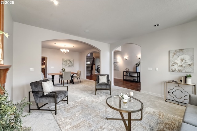 living room featuring carpet floors and an inviting chandelier