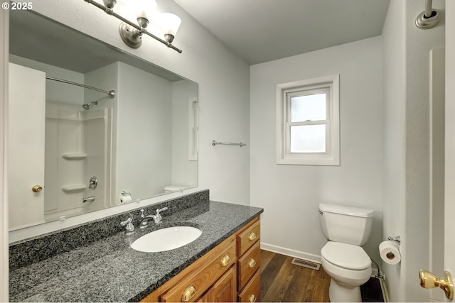 full bathroom with visible vents, toilet, wood finished floors, baseboards, and vanity