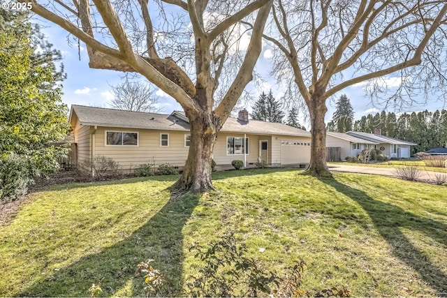 view of front facade featuring an attached garage, a chimney, and a front lawn