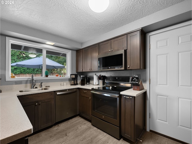 1890 NW 6th Dr, Gresham, OR 97030 - kitchen with stainless steel appliances, dark brown cabinets, and light countertops