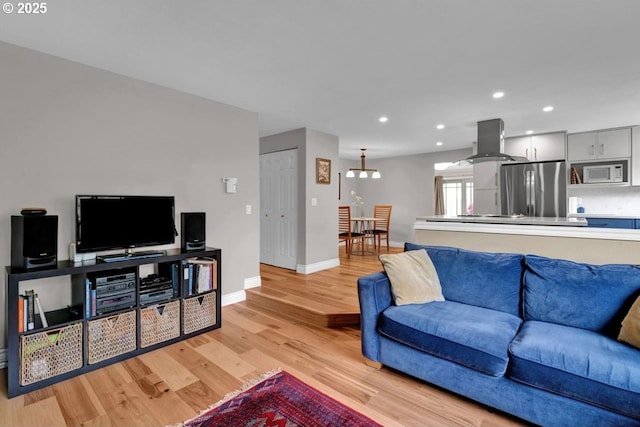 living area with recessed lighting, baseboards, and light wood finished floors