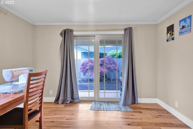 dining room featuring baseboards, ornamental molding, and light wood-style flooring