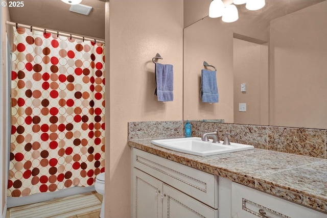 bathroom with vanity, a shower with curtain, toilet, and visible vents