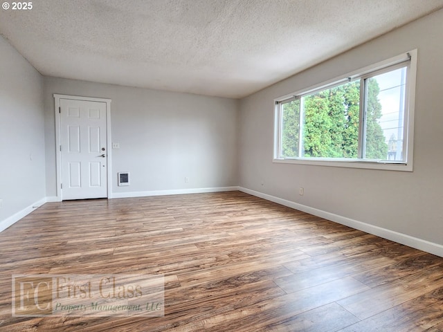 5516 NE Hoyt St, Portland, OR 97213 - empty room with wood finished floors and a textured ceiling
