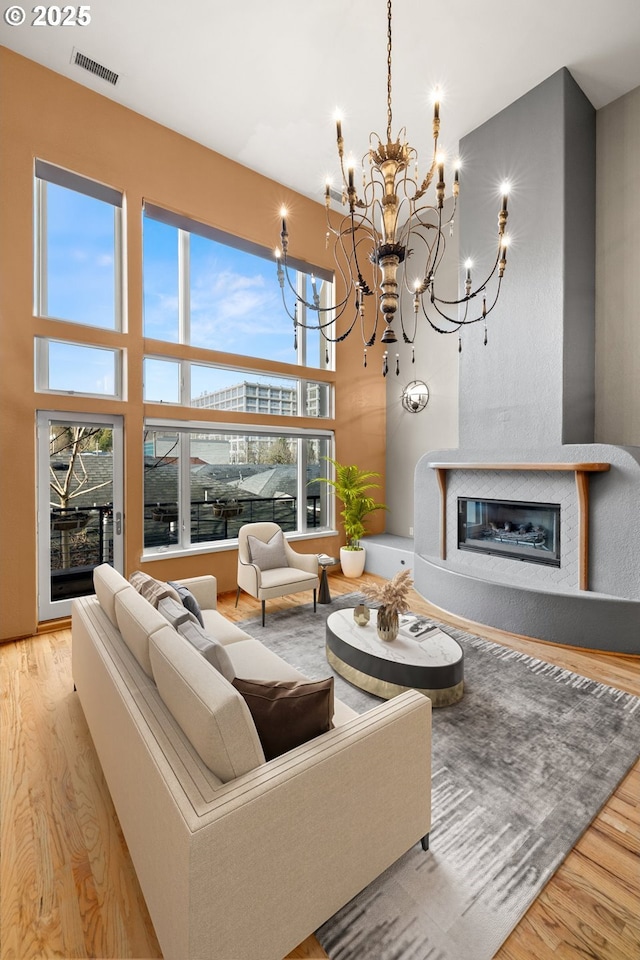 living room with light hardwood / wood-style flooring and an inviting chandelier