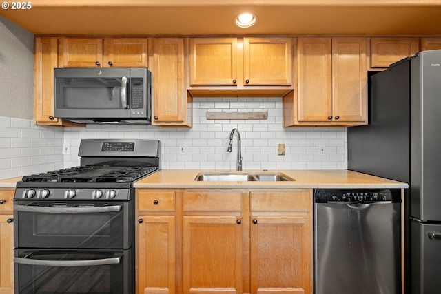 kitchen featuring sink, appliances with stainless steel finishes, and tasteful backsplash