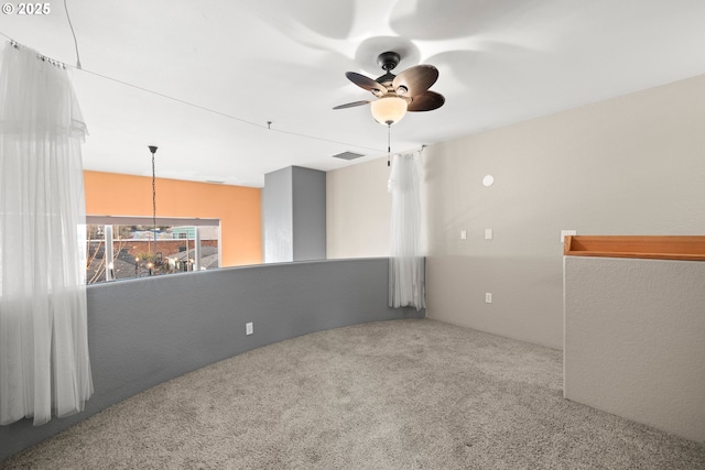 unfurnished room featuring carpet and ceiling fan