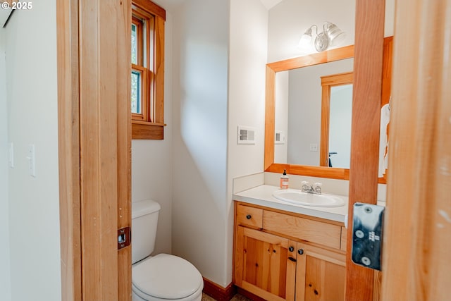 half bath featuring toilet and vanity