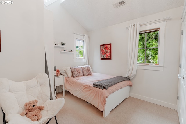 bedroom featuring vaulted ceiling, light colored carpet, multiple windows, and baseboards