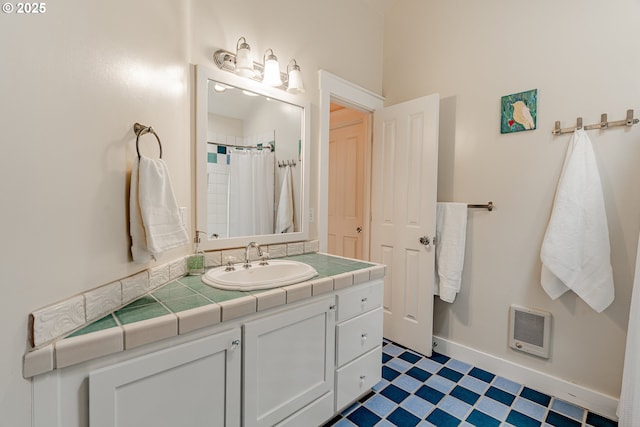 bathroom featuring baseboards, heating unit, vanity, and a shower with curtain
