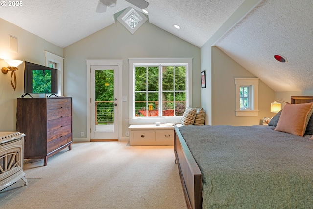 bedroom with a textured ceiling, access to exterior, lofted ceiling, light carpet, and ceiling fan