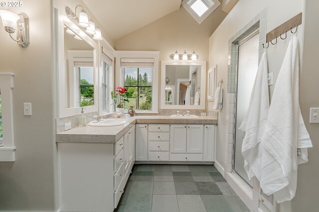 bathroom featuring lofted ceiling, double vanity, a stall shower, and tile patterned flooring