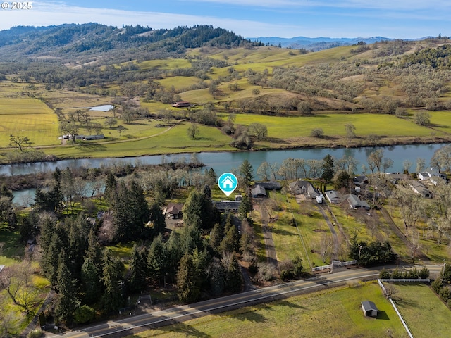 aerial view with a water and mountain view and a rural view