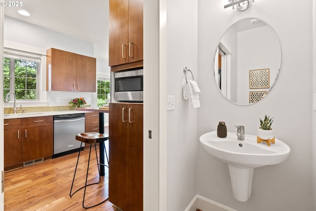 12842 Boones Ferry Rd, Lake Oswego, OR 97035 - bathroom with a sink, healthy amount of natural light, wood finished floors, and baseboards