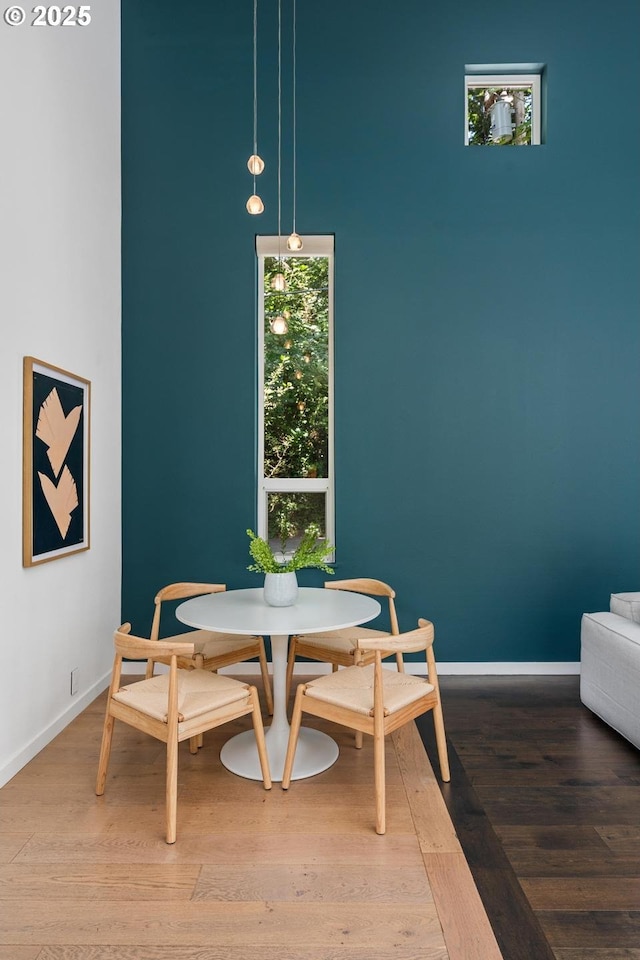 5210 SW Hewett Blvd, Portland, OR 97221 - dining area featuring wood finished floors and a high ceiling