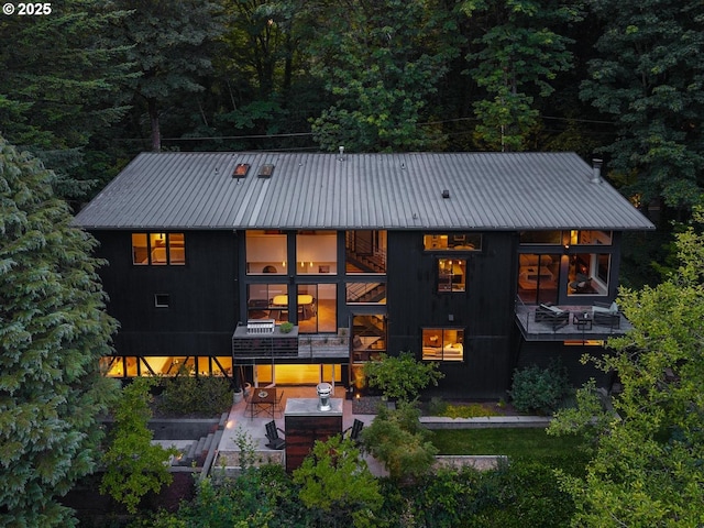 5210 SW Hewett Blvd, Portland, OR 97221 - view of front of home featuring a balcony, a metal roof, and a patio area