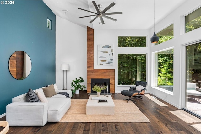 5210 SW Hewett Blvd, Portland, OR 97221 - living room with high vaulted ceiling, plenty of natural light, a ceiling fan, a large fireplace, and wood finished floors